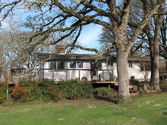 Back of house with deck