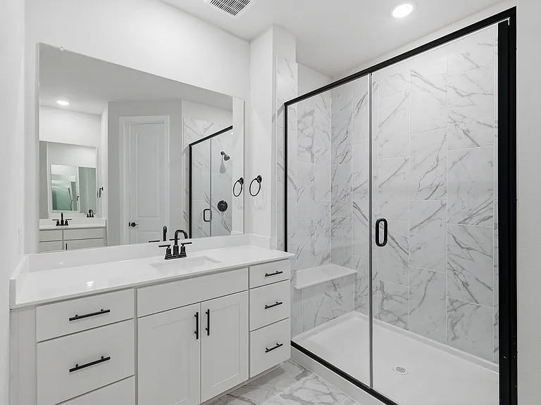Primary bathroom with separate vanities and a huge walk-in closet