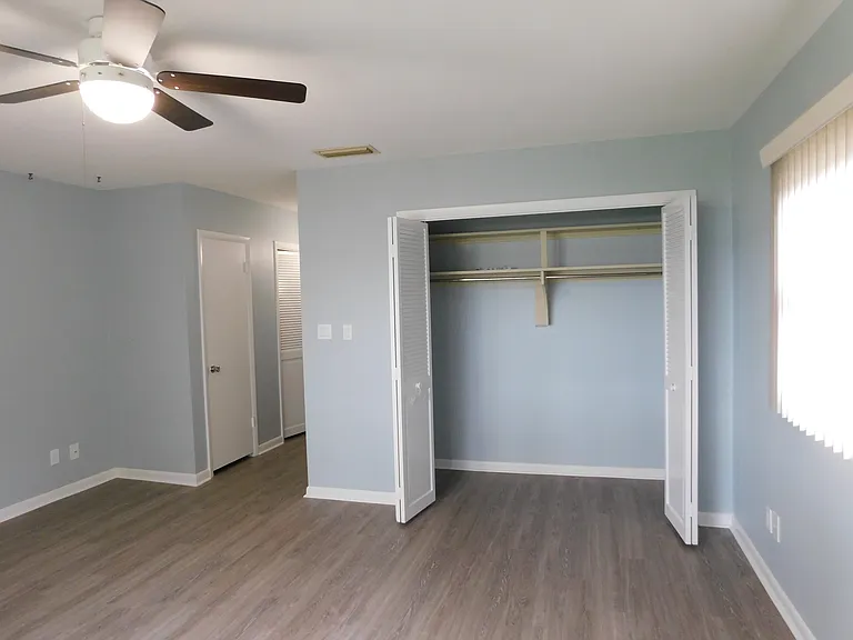 Now we're in the master bedroom facing east. You get a sizable closet behind bi-fold doors.