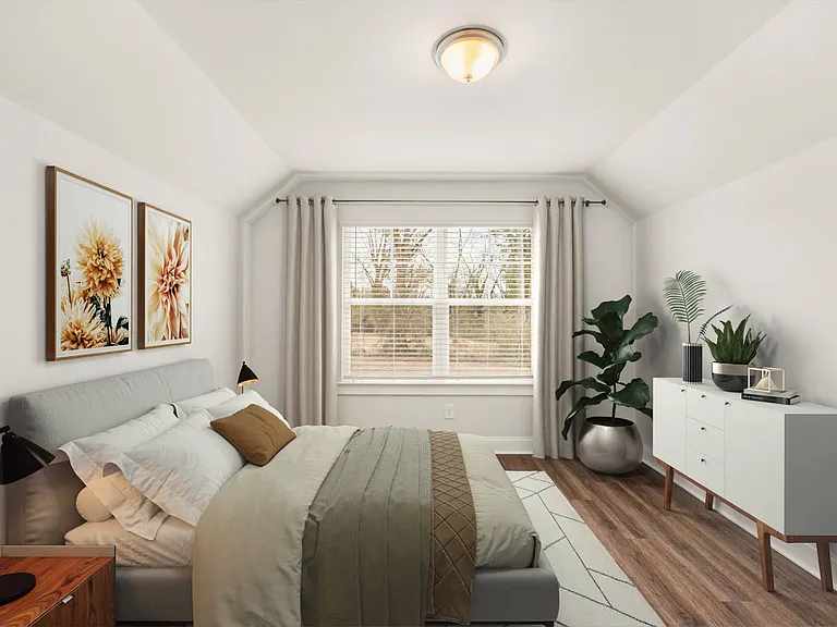 Secondary bedroom with queen size bed and large window letting in a ton of natural light.