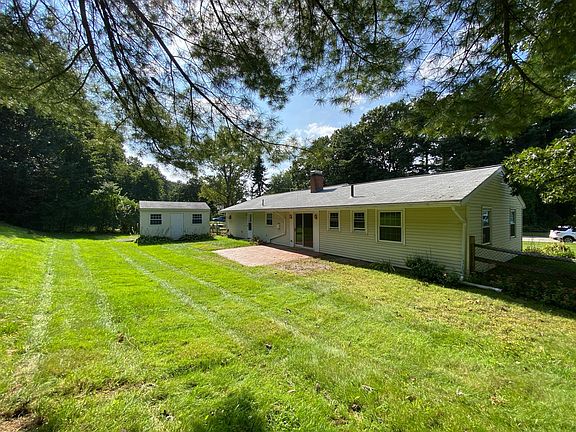 Fully Fenced Backyard with patio and large storage shed.