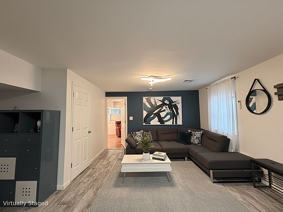 Huge living room - partially virtually staged. couch, coffee table, storage, bench are all included in the rent (or we can deliver vacant).