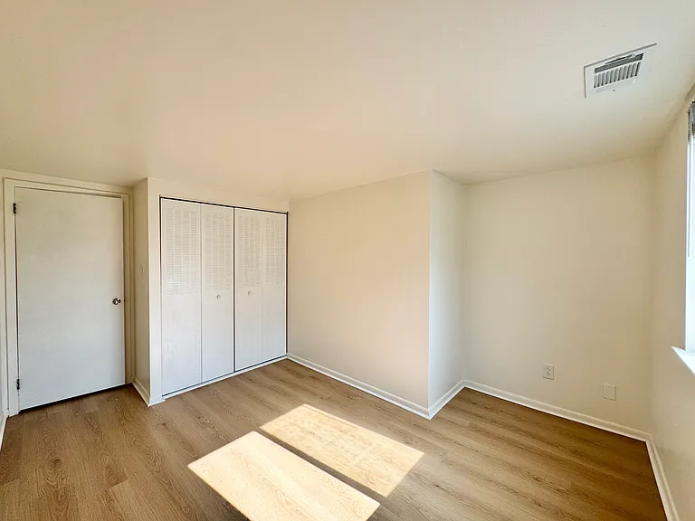 Secondary bedroom with a double-door closet