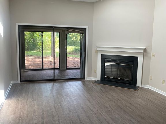 Freshly painted living space which opens to a brick sunroom.