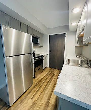 View of the kitchen from the dining area. You can imagine yourself using these new stainless appliances. Oh, new can lights too!