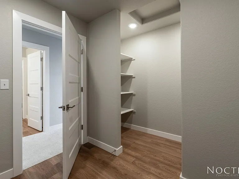 Huge laundry room with extra storage that is upstairs with all of the bedrooms. Washer and dryer will be provided. (Photo of another unit with similar finishes and quality.)
