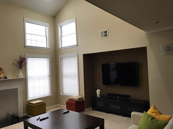 Living Room (16.6 x 22): Carpeted floors, two story windows,