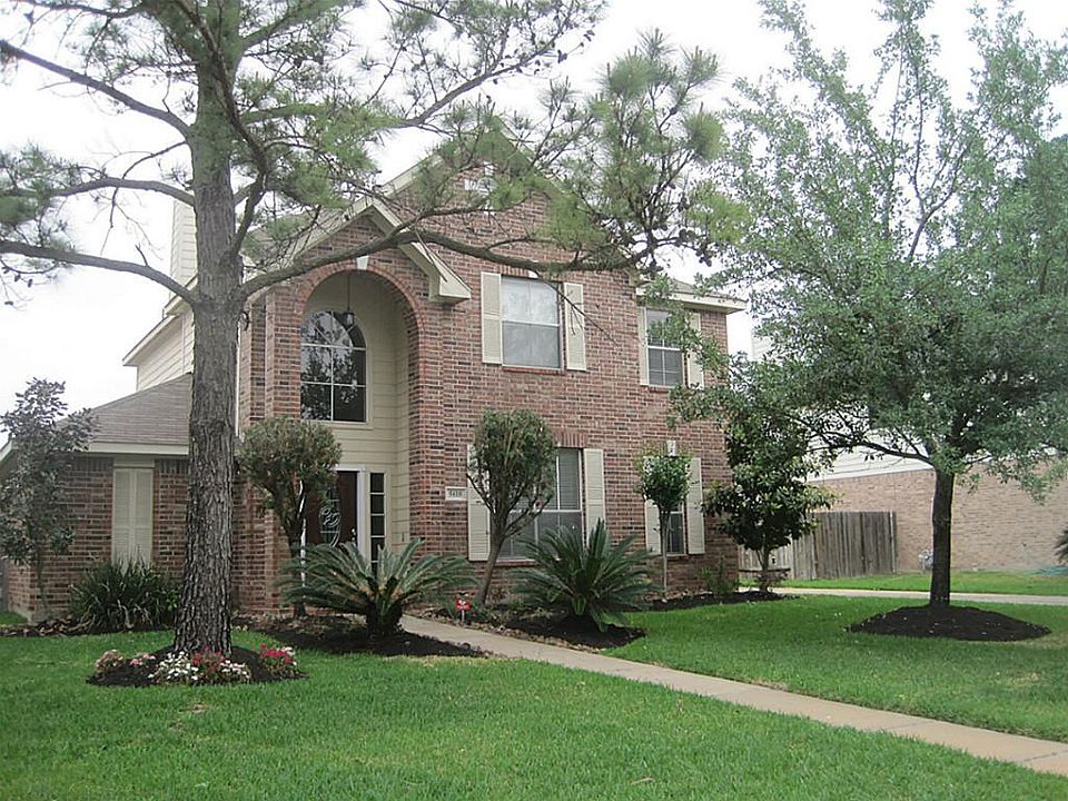 Beautiful home with mature trees in yard.