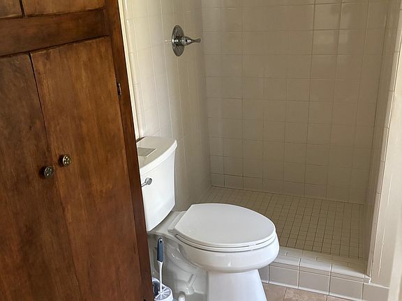 Walk-in shower, limestone floor, lots of cabinet space.