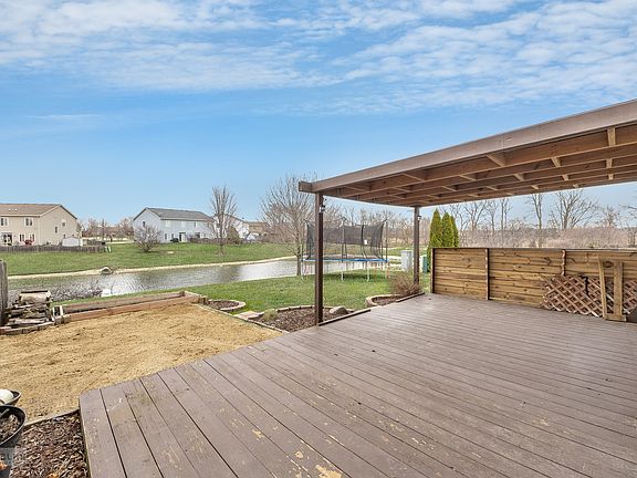 Enjoy the pond view~There's a great sandbox for the kiddos & fire pit for the entire family!