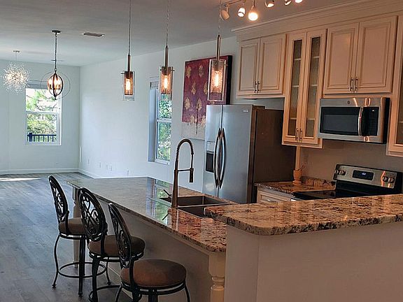 Another kitchen view from the vestibule. Nice glass front cabinets. Picture in background does not stay.