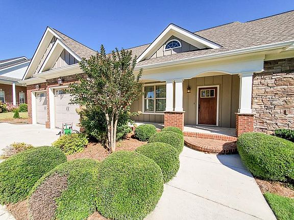Exterior has stacked stone, brick and siding in perfect condition.