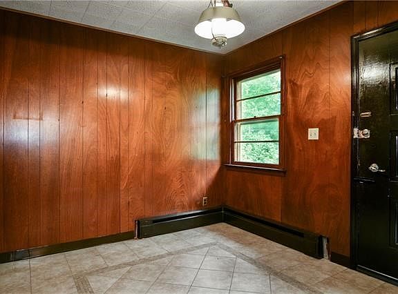 Another view of paneled entry foyer