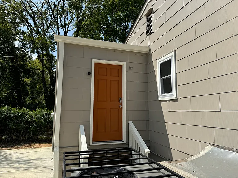 back door of house leads to laundry room freshly painted. Features outside door light and electronic lock