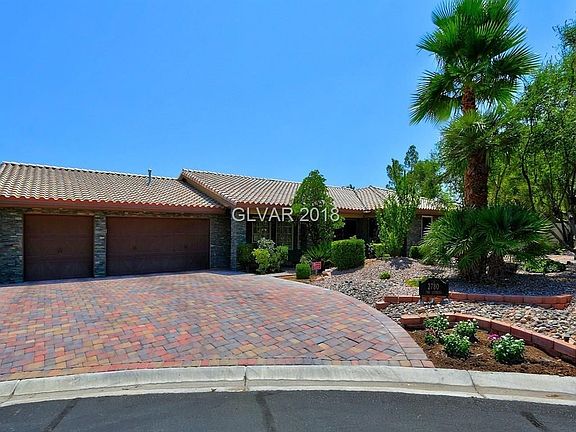 Three car garage with brick pavers on the driveway