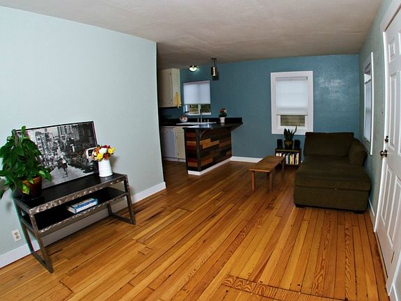 The living room features recycled wood floors that create that old world ambiance so desired in this old established neighborhood.