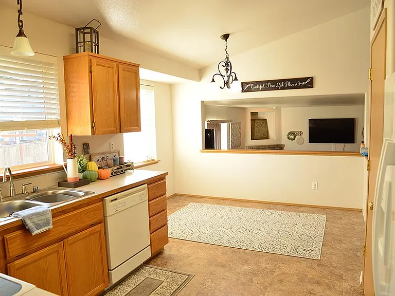 Kitchen and breakfast dining area that overlooks family room. Large pantry on right