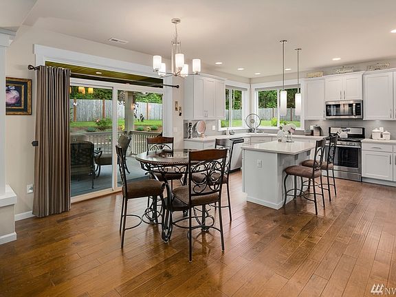 Bright and spacious, island kitchen with adjacent large dining area.