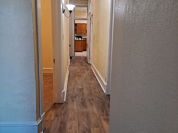 Hall entryway looking towards the kitchen in back