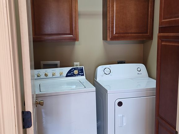 Washer dryer room; lots of cabinets