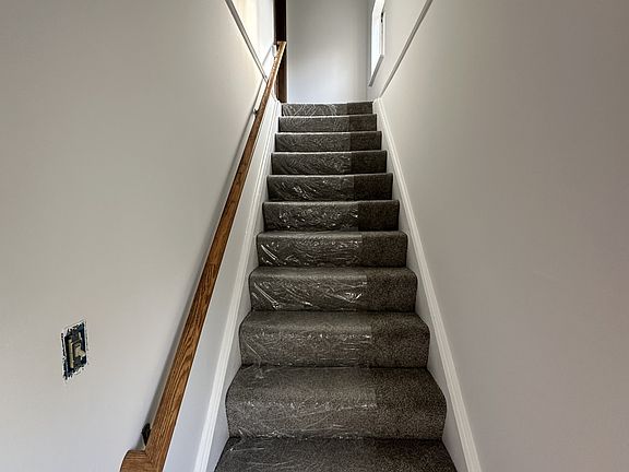 Stairs going up to the apartment from 2nd floor landing. Apartment has new flooring throughout.