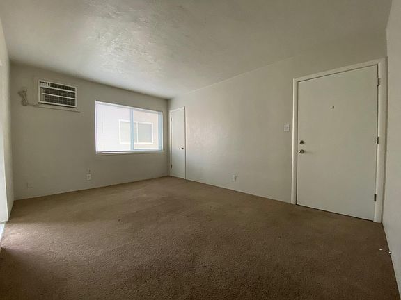 Living room from hall door. Walls are light grey.