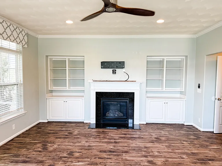 Living room with gas fireplace and built-in shelving.