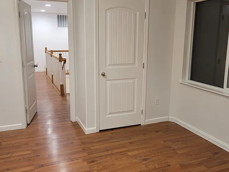 looking back down the hall. there are two room on the left side of hallway (bath and laundry)