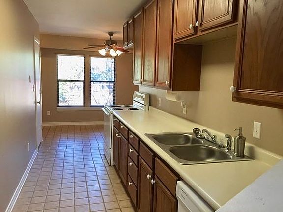Tile flooring downstairs, kitchen with oven, dishwasher and new sink with disposal.