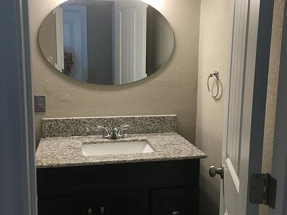 nice vanity in bathroom with granite top