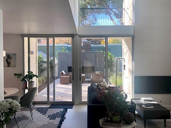 Same view with furniture - Living spaces is characterized by soaring ceilings flooded with natural light connecting the interior to exterior.