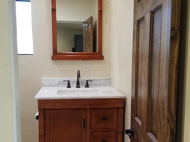 Bathroom with new vanity and matching mirror.