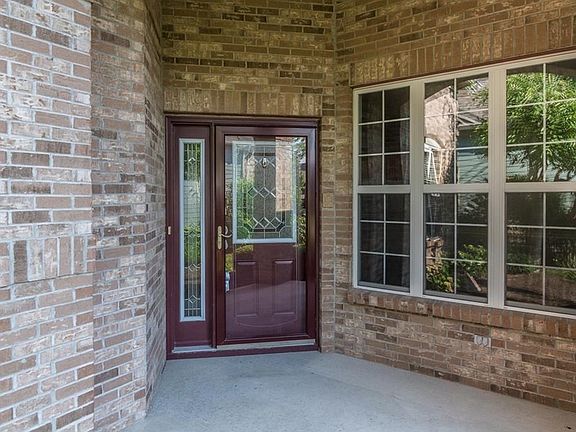 An inviting entry that is sheltered to protect your guests from the harsh elements!  Beautiful brick is timeless...