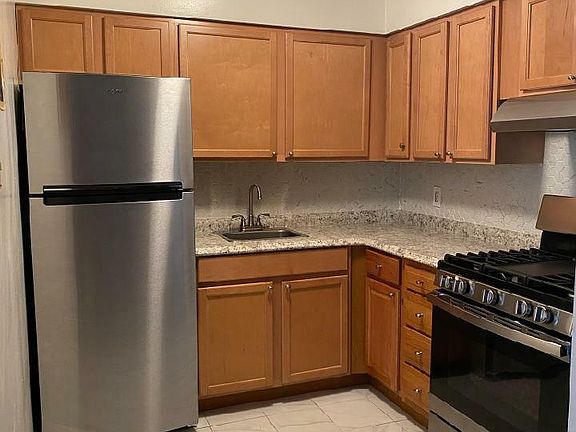 NEW Stainless steel Fridge & Stove, NEW Counters, Ceramic tile floor