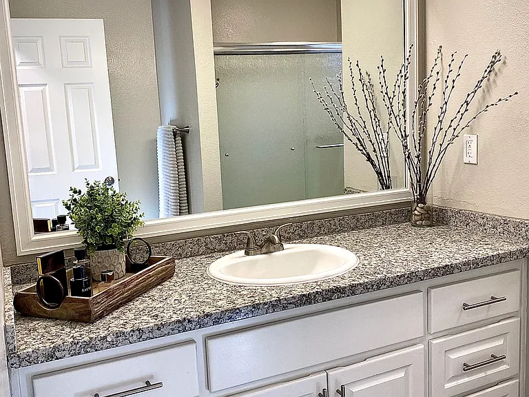 Full bathroom with granite counters