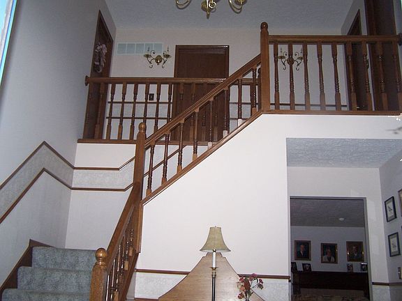 Foyer with cathedral ceiling and open staircase