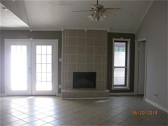 Formal living room features a wood fireplace with gas connections.