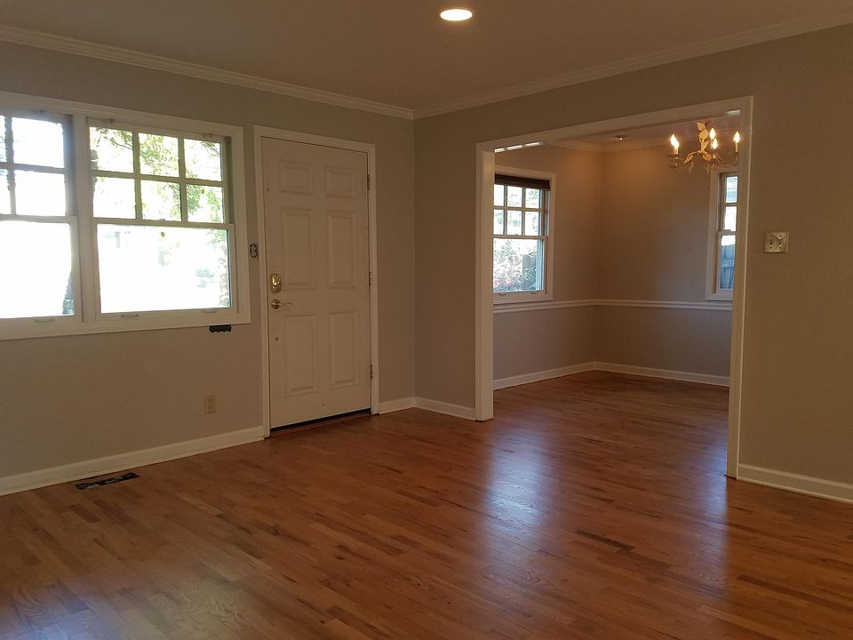 Living room entrance and dining room. Newly refinished hardwood floors and recessed lighting.