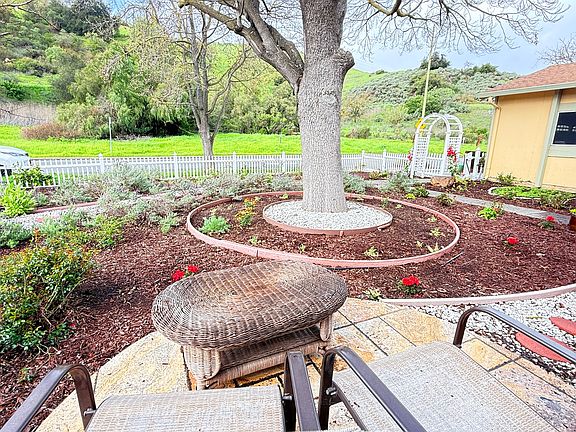 Relax with this view of the front yard garden and the hills of the County Park.