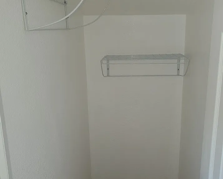 Closet with 2 racks for clothes.