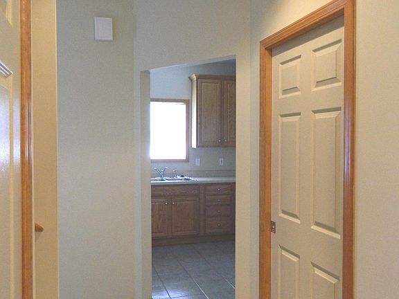 Central hall leads to mud/laundry room (right), kitchen and great room.