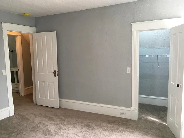 Upstairs bedroom, showing closet. Shows door to upstairs bathroom.