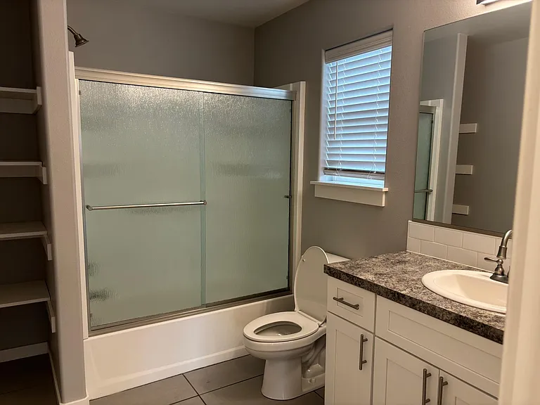 Tub and shower in this big bathroom with room to store all of your toiletries
