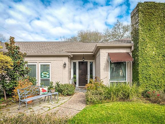 You're greeted by a meandering path taking you up the walk way to the rich wooden door. Speckled with a jewel magnolia, knock our roses, irises and awnings with bench area, this elevation beckons you in.