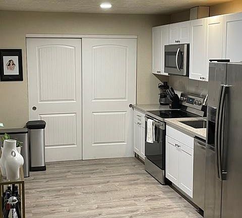Kitchen, and behind the double doors is dryer and washer