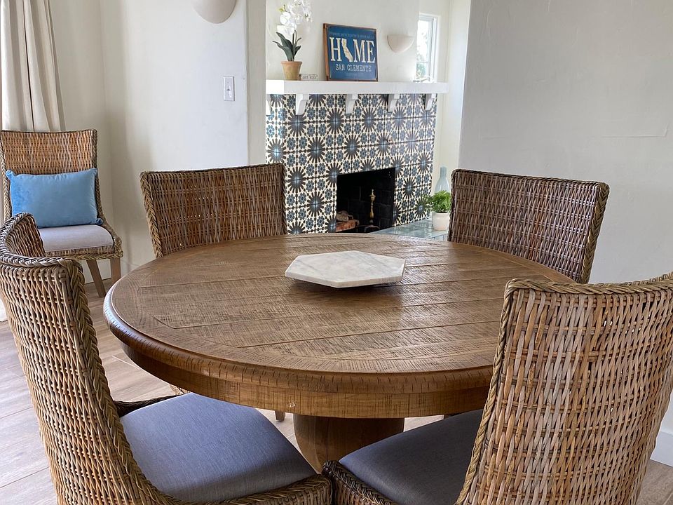 Relaxing dining room with 48" round table. Living room fireplace in the background.
