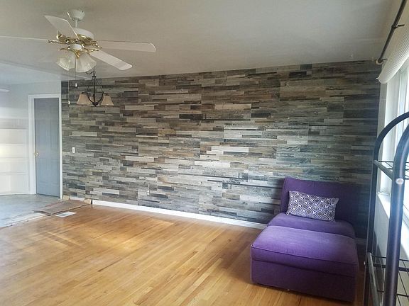 Living room with tile accent wall (before new luxury vinyl plank floors).