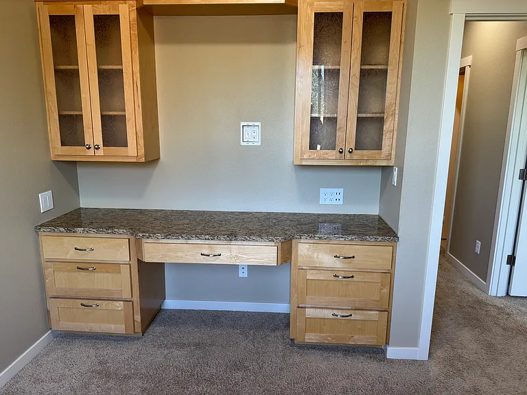 bedroom with built in desk and cabinets
