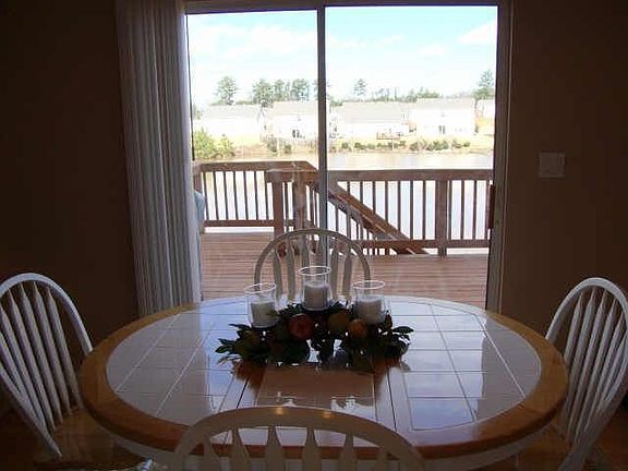 Sunny breakfast area has view of deck and lake