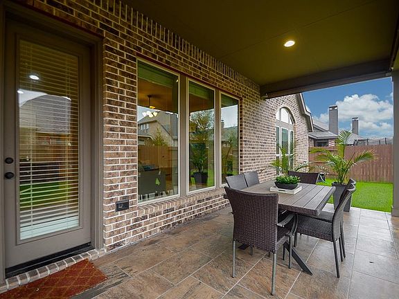 The relaxing covered patio offers an immaculate flooring to set up all your outdoor furniture safely.